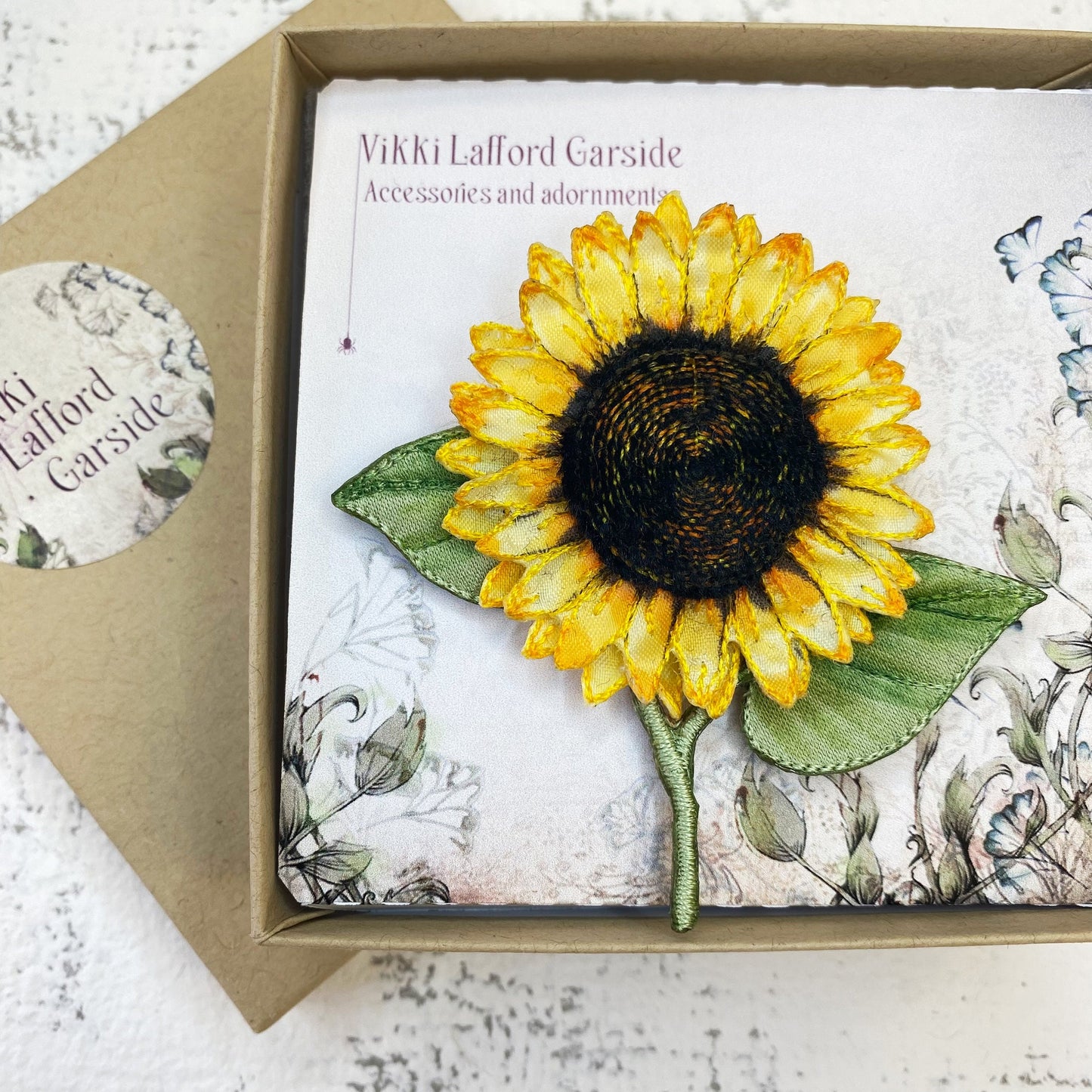 Bright and cheery fabric sunflower brooch with leaves