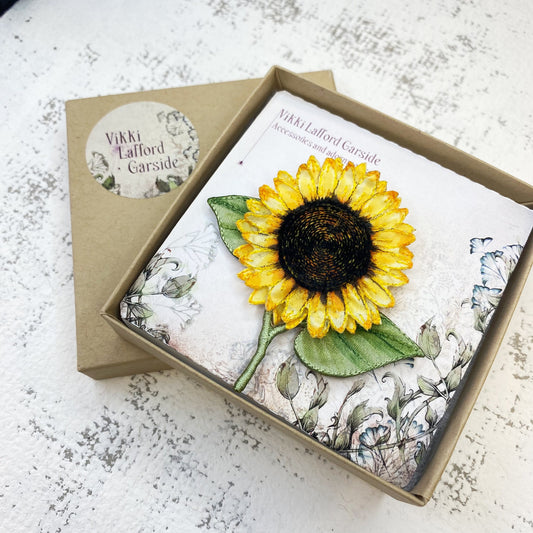 Bright and cheery fabric sunflower brooch with leaves