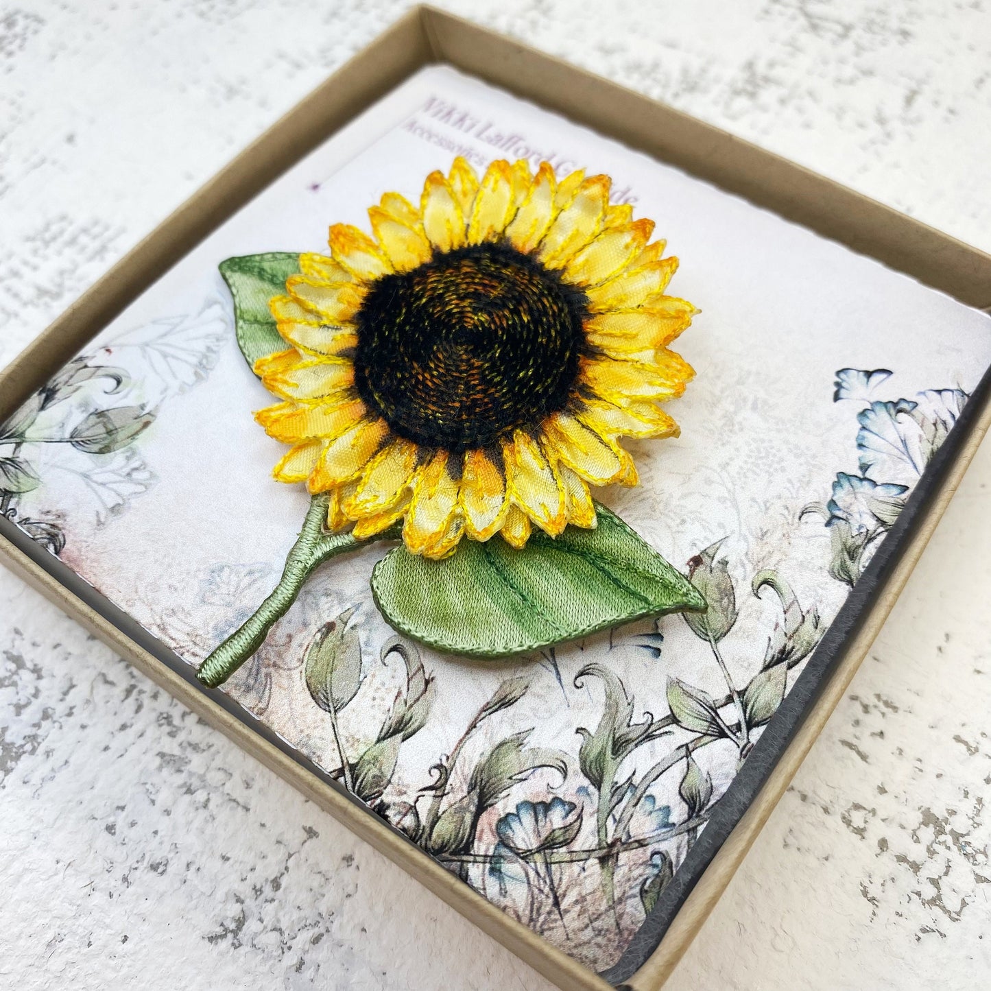 Bright and cheery fabric sunflower brooch with leaves
