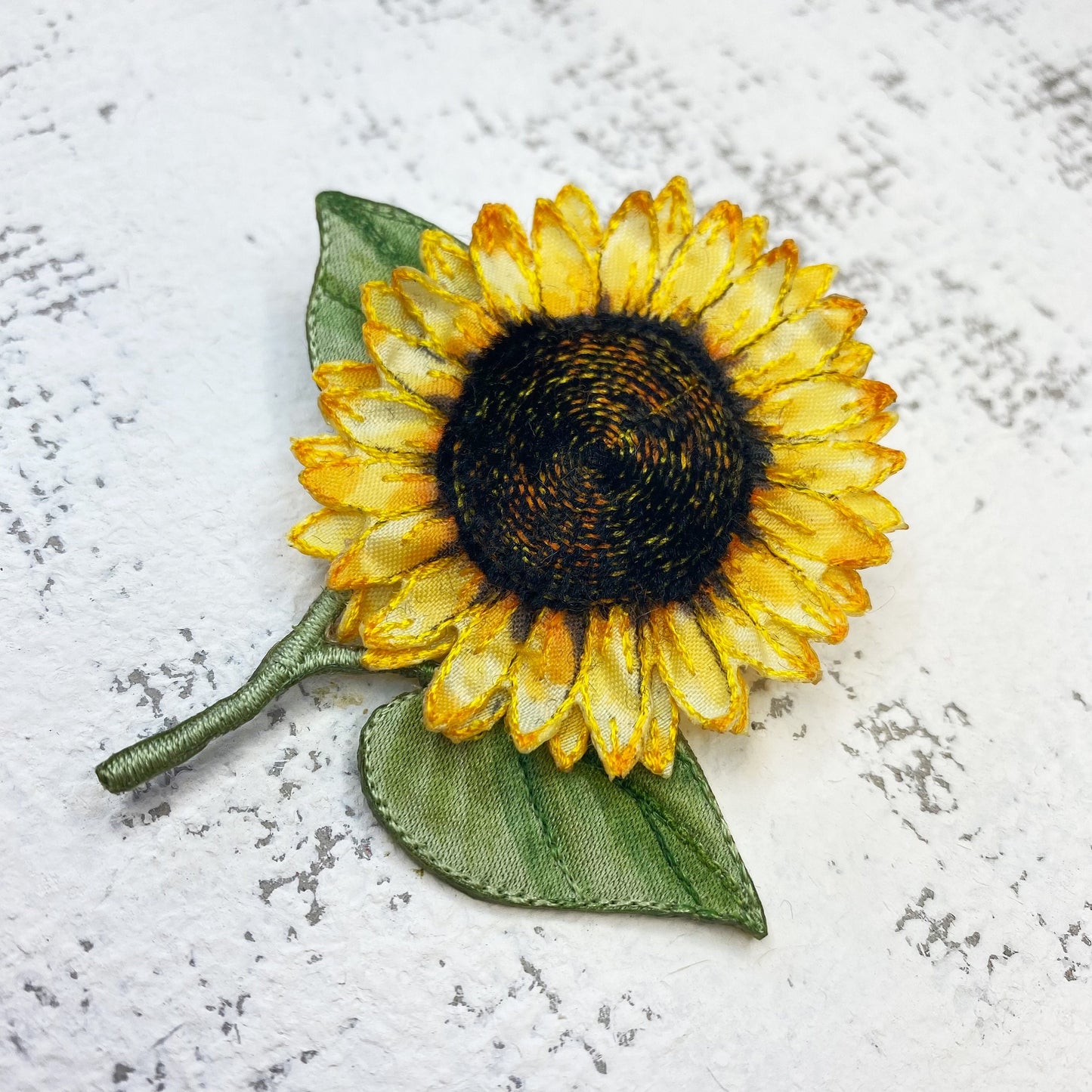 Bright and cheery fabric sunflower brooch with leaves