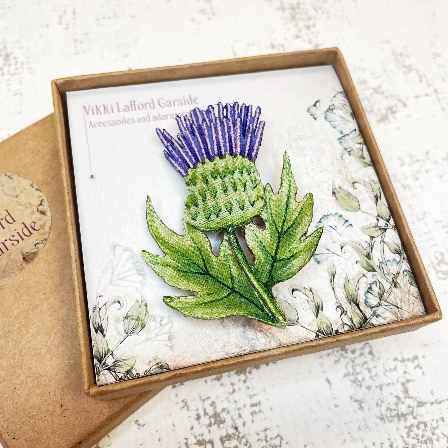 Embroidered and hand painted thistle brooch