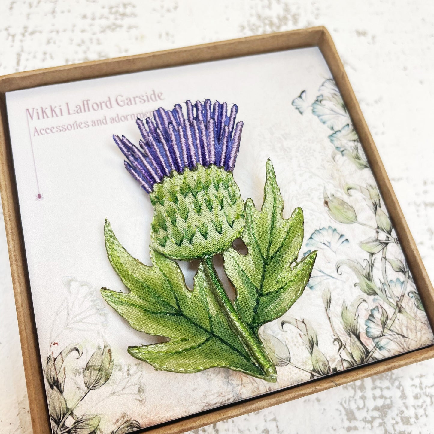 Embroidered and hand painted thistle brooch
