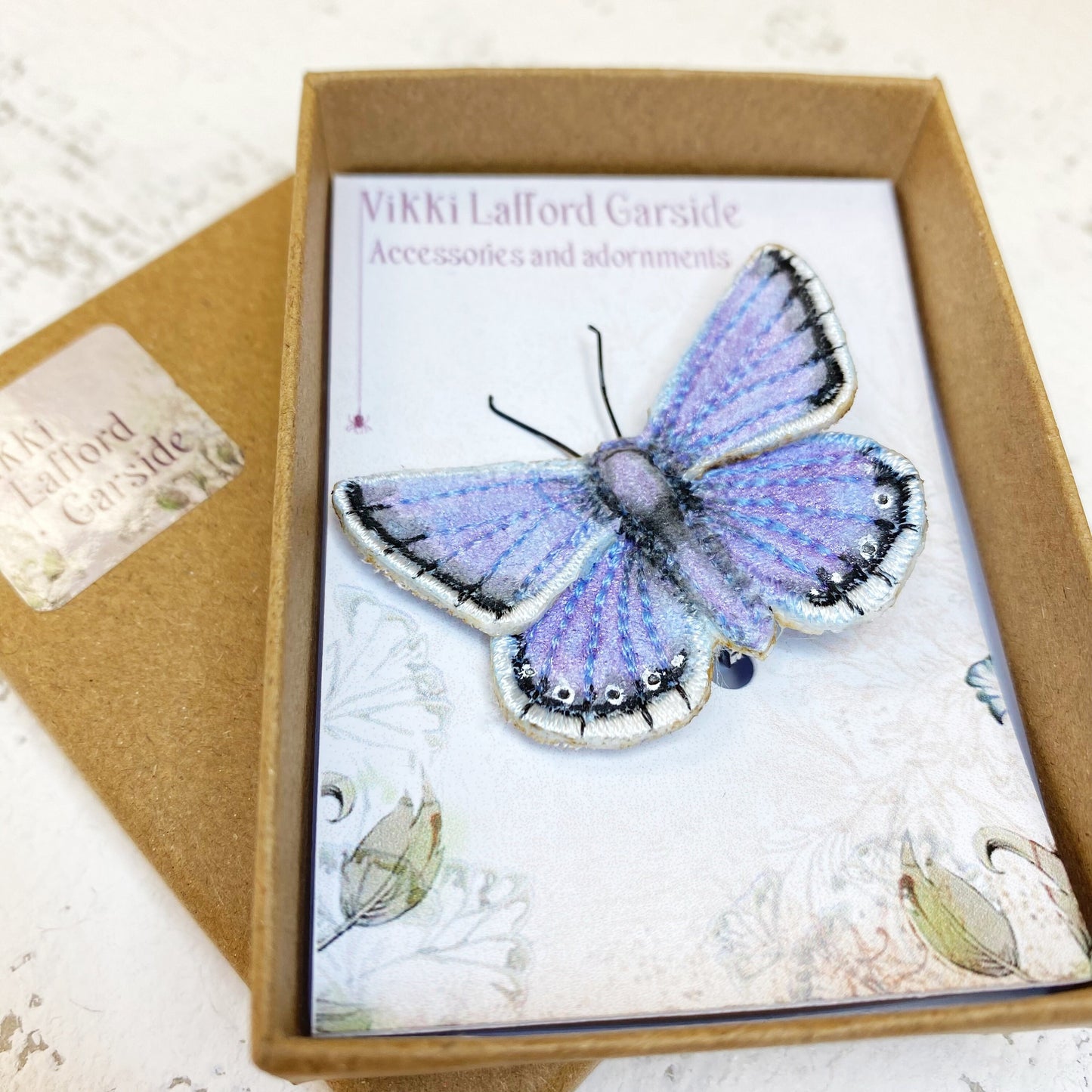 Blue and white butterfly brooch