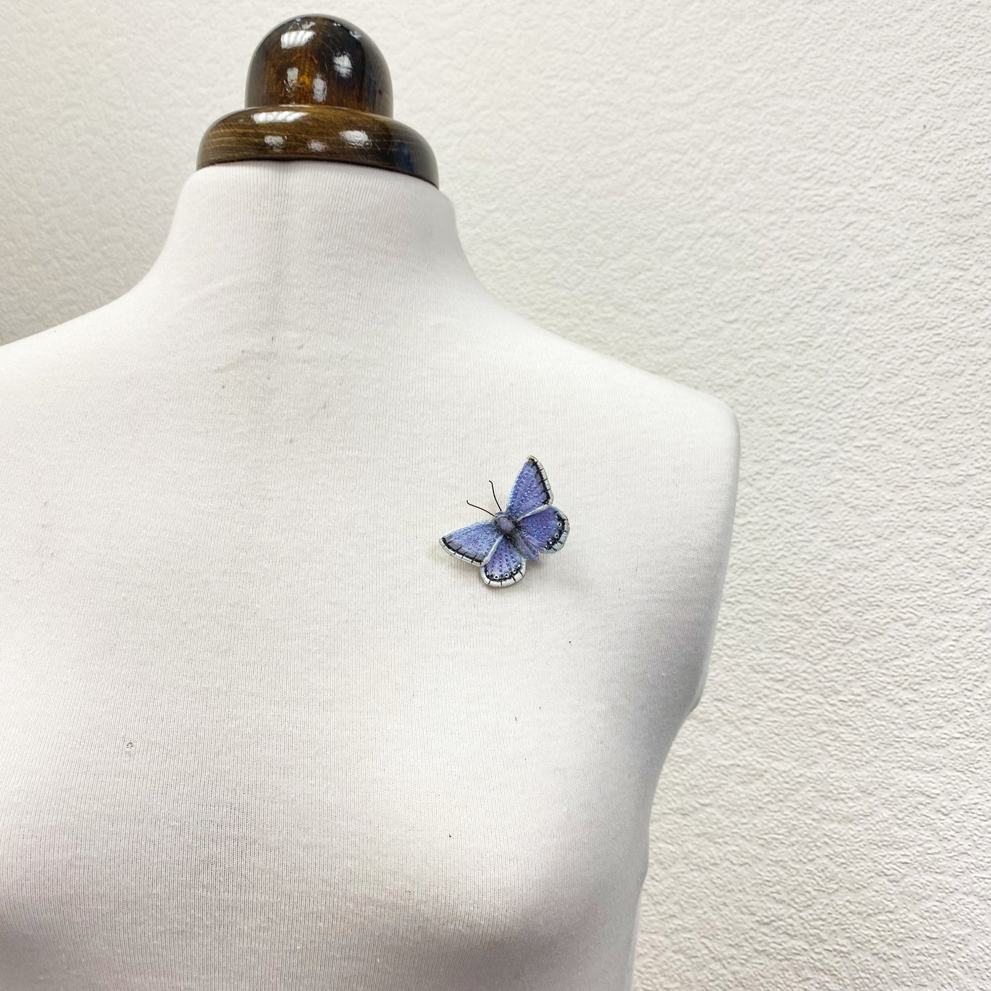 Blue and white butterfly brooch