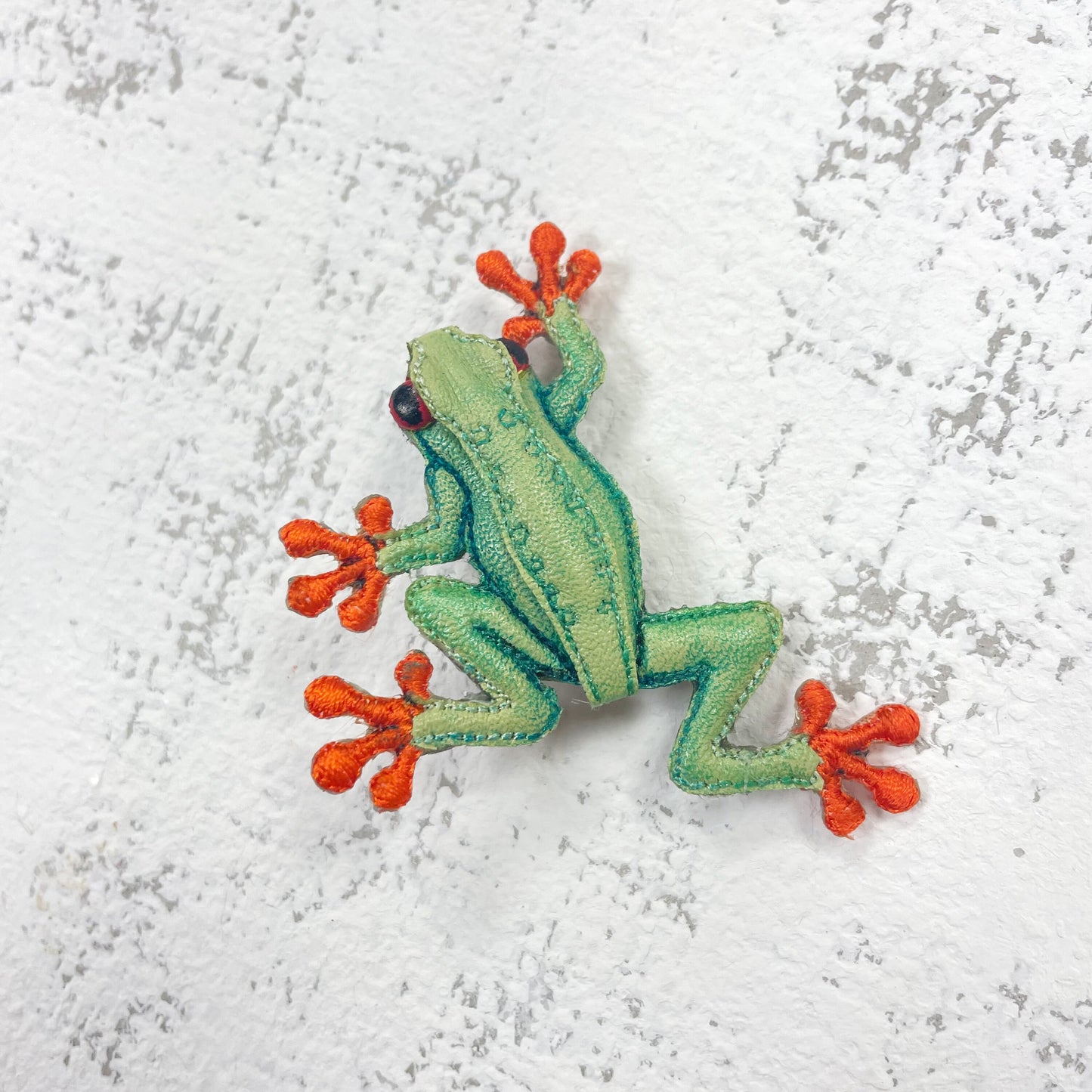 Handcrafted green and orange frog brooch