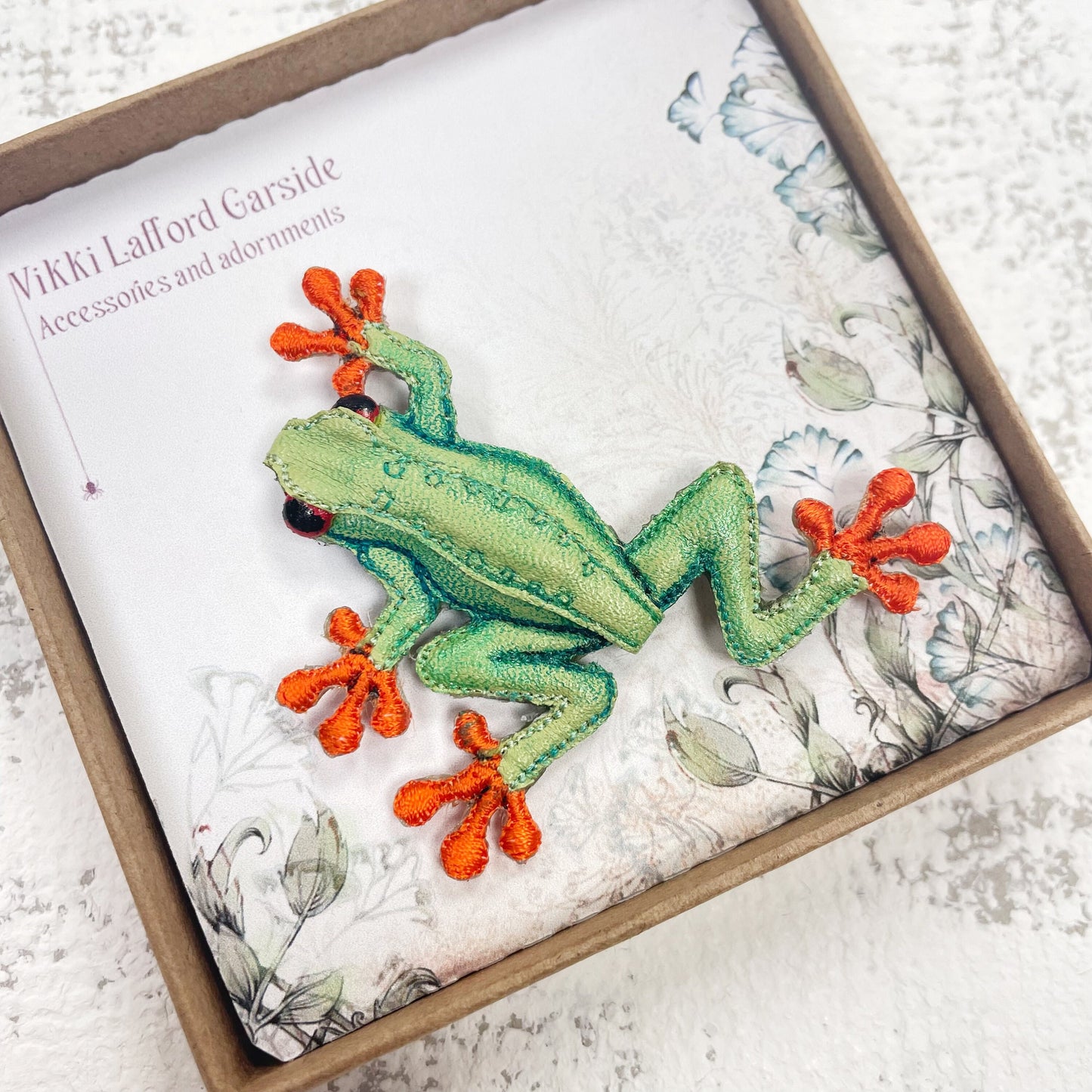 Handcrafted green and orange frog brooch