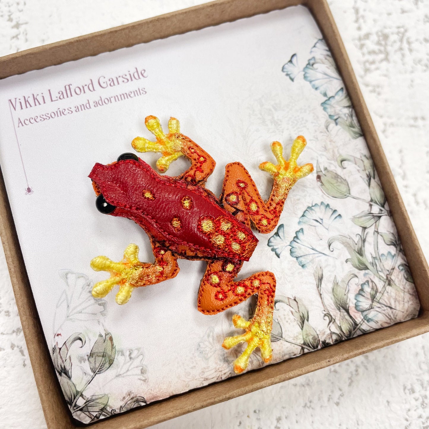 Handcrafted red and yellow spotted frog brooch