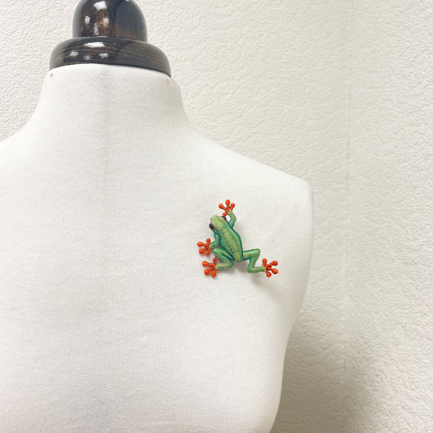 Handcrafted green and orange frog brooch