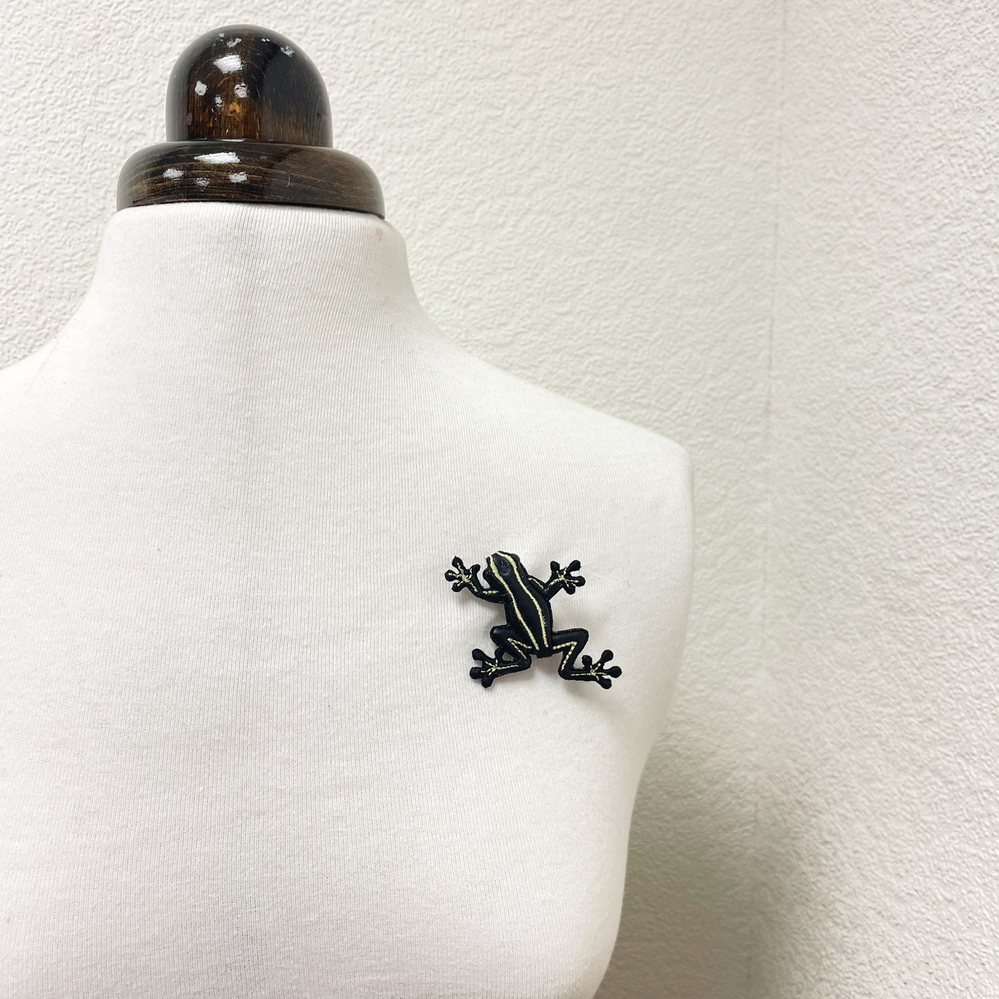 Handcrafted black and yellow striped frog brooch